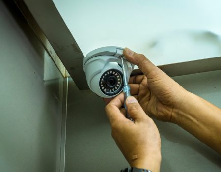 Technician installing CCTV system in elevetor area